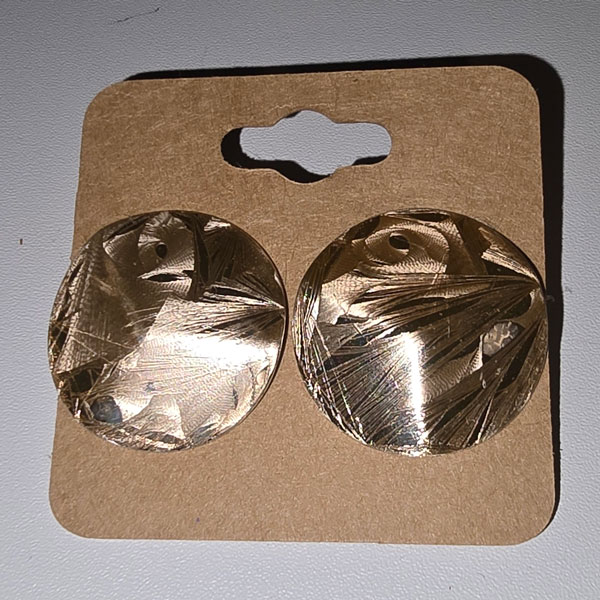 Large gold post earrings with a swirled button design