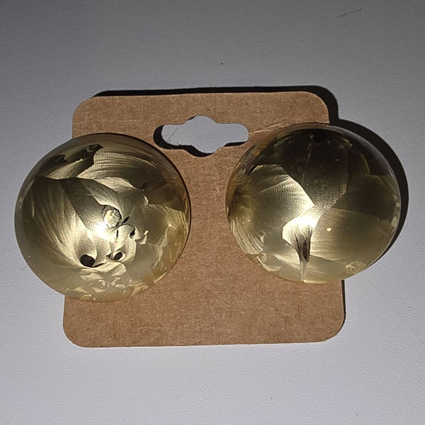 Large gold post earrings with a swirled button design